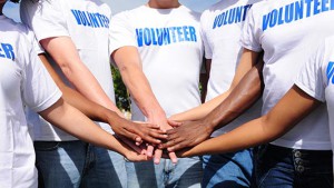 multi-ethnic volunteer group hands together