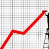 Man standing on step ladder painting ascending red line on graph paper