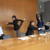 Executives in conference room stretching