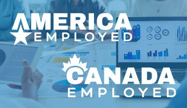 A business meeting with a tablet, documents, and a laptop showing charts. Transcribed text says: America Employed Canada Employed
