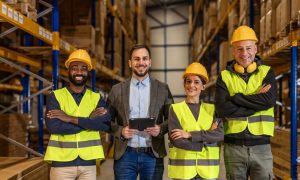 Warehouse team collaborating in a calm, organized workspace, illustrating balanced workloads, supportive leadership, and efficient supply chain operations designed to reduce burnout and improve performance incentives.